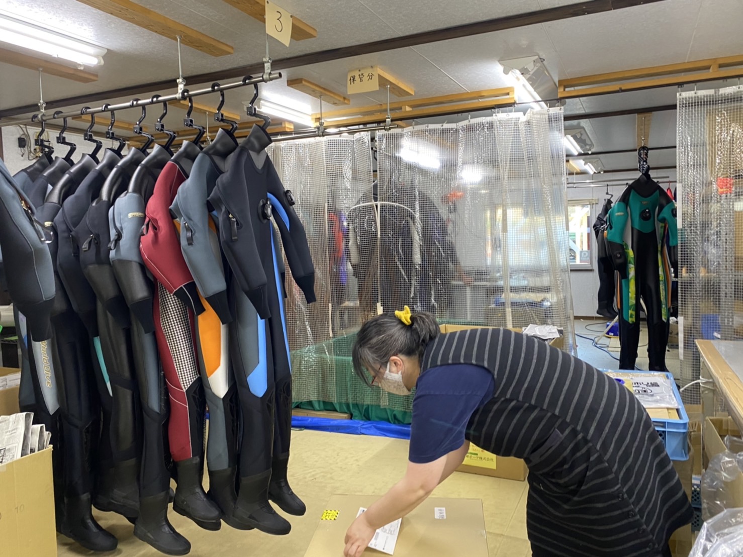 完成したスーツを出荷準備している
