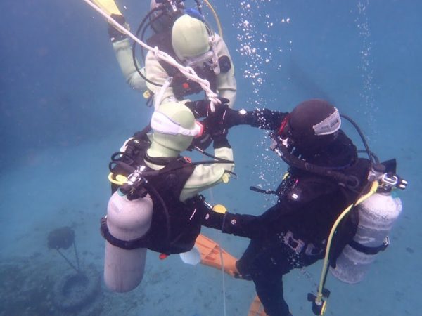 海の中で生徒とインストラクターがスキルの練習をしている様子